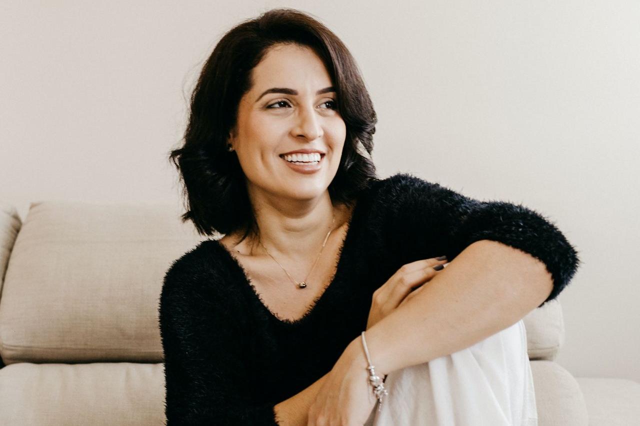 woman in black long sleeve shirt sitting on white couch